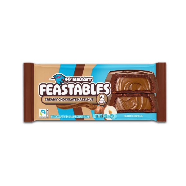 Feastables Mr Beast Hazelnut Cups Feastables Mr Beast Hazelnut Cups da 40 gr. Scopri i nuovi Mr Beast Feastables Hazelnut Cups: morbidi gusci di cioccolato al latte ripieni di una crema vellutata alla nocciola che si scioglie in bocca. Uno snack premium, irresistibile e cremoso, creato dal brand di Mr Beast. E' per chi ama i sapori ricchi e avvolgenti. Perfetti per una pausa golosa da veri intenditori. Ogni pacchetto contiene 2 golose coppette.